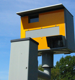 Fixed speed cameras use microwaves. The mobile ones use infra-red